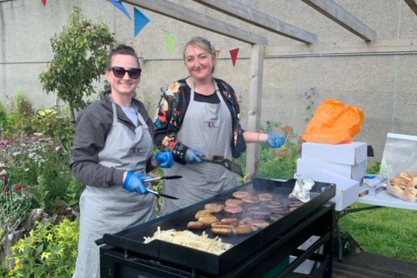 LVC staff member and Laura from Cyrenians cooking on the BBQ during our BBQ at Linburn