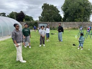 A group of children play badminton during our BBQ at Linburn