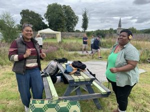 A veteran and a wife of a veteran pose at a picnic table during our BBQ at Linburn