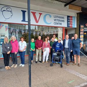 Group photograph of Veterans with Tim Hyams from The Army Benevolent Fund outside the centre