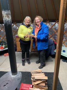 Two female veterans standing with woodwork pieces