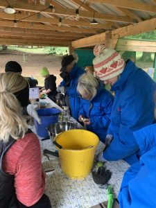 A group of female veterans crafting around a table during OP Cairngorms trip
