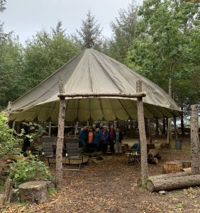 Female veterans standing in a group under a yurt tent
