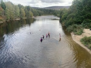 A group of female veterans wild swimming in a river during OP Cairngorms trip