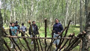 Children pose in front of branches during OP Cairngorms trip