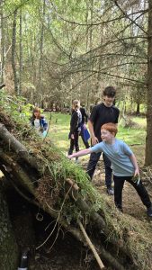 Children observing a hut made during a trip to OP Cairngorms