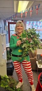 One of our female veterans holding a Christmas wreath made during our Christmas Wreath making session