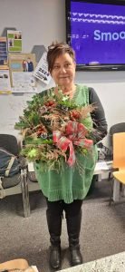 One of our female veterans holding a Christmas wreath made during our Christmas Wreath making session
