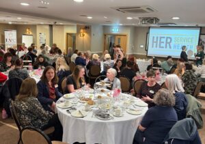 Groups of female veterans sat at tables