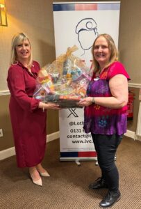Female Veteran raffle winner receiving her hamper from LVC's CEO