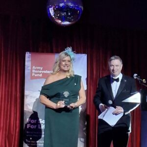 CEO, Pauline, on stage accepting her Scottish Veterans Awards from Mark McKenzie